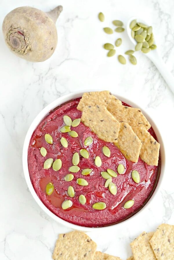 Creamy White Bean Beet Hummus made with 6 healthy ingredients and a pumpkin surprise. A hearty dip that's remarkably delicious, tastes nothing like beets and sure to be the star of the party! Vegan + Gluten Free + Low Calorie