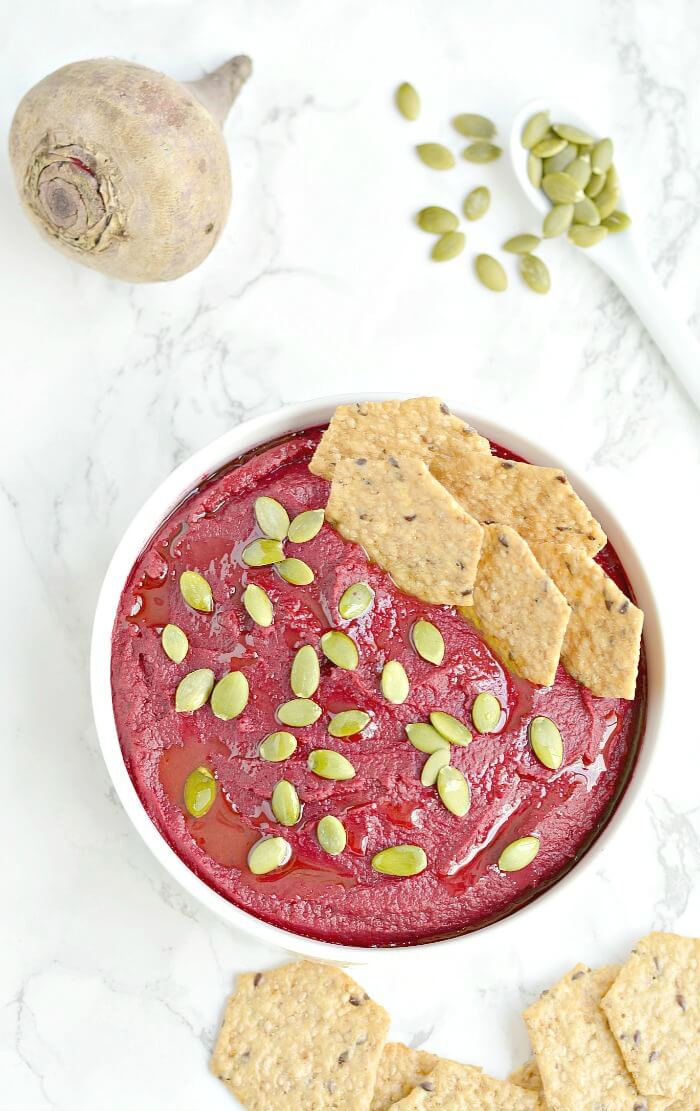 Creamy White Bean Beet Hummus made with 6 healthy ingredients and a pumpkin surprise. A hearty dip that's remarkably delicious, tastes nothing like beets and sure to be the star of the party! Vegan + Gluten Free + Low Calorie