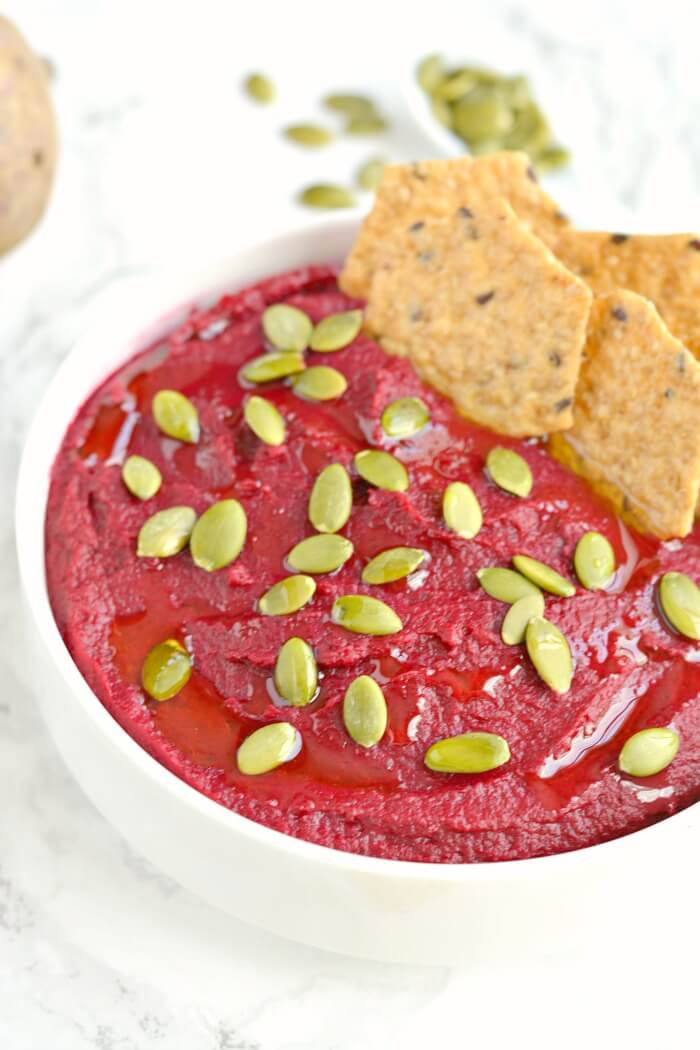 Creamy White Bean Beet Hummus made with 6 healthy ingredients and a pumpkin surprise. A hearty dip that's remarkably delicious, tastes nothing like beets and sure to be the star of the party! Vegan + Gluten Free + Low Calorie