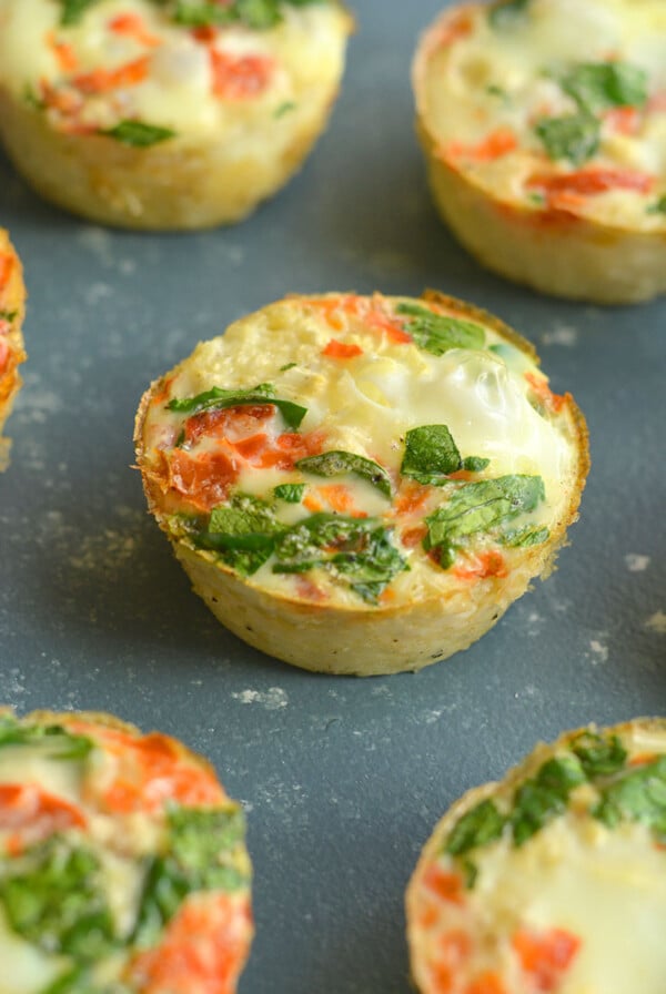 Cauliflower Egg Muffins made with cauliflower rice! With 6 grams of protein & less than 1 gram of carbs, these egg muffins make a nutritious make ahead breakfast you can take with you on-the-go! Paleo + Gluten Free + Low Calorie.