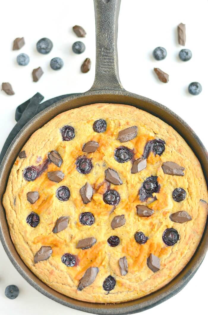 Pumpkin Blueberry Chocolate Skillet Cake! Savor the flavors of fall with swirls of pumpkin and rings of blueberries & chocolate in a thick coconut flour skillet cake that's healthy, EASY & addicting! The perfect Paleo + Gluten Free fall breakfast, dessert or snack. 