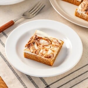 A slice of apple cheesecake bar on a plate.