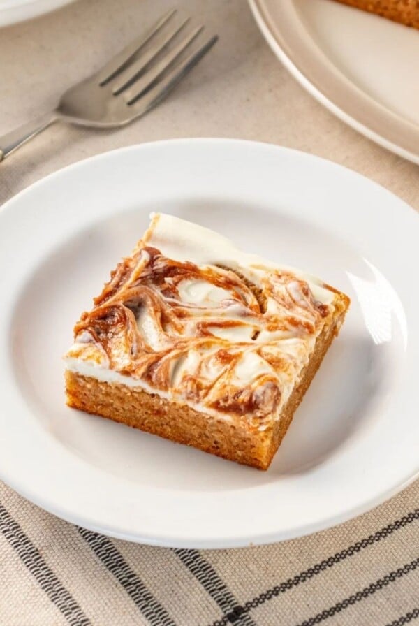 A slice of apple cheesecake bar on a plate.