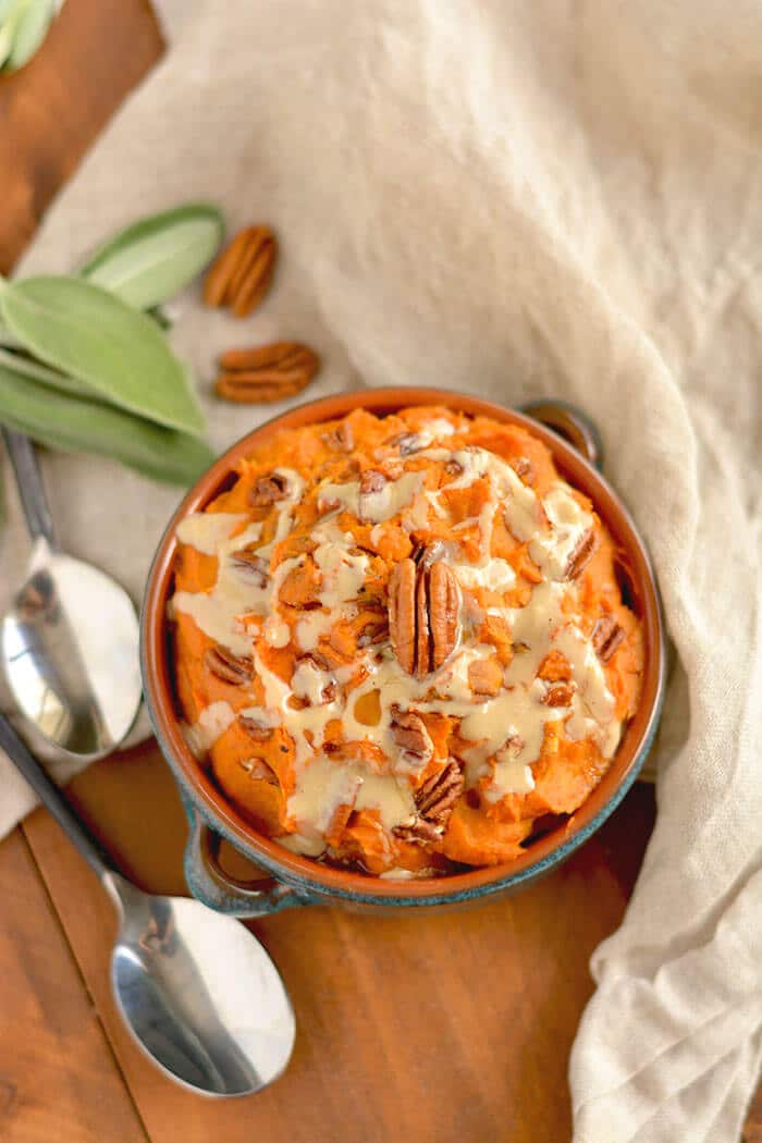 This warm Maple Tahini Butternut Sweet Potato Mash is a healthier version of sweet potato casserole. Lightly sweetened with maple syrup, savory tahini sauce and topped with pecans to make the perfect side dish for fall, winter and holiday gatherings. Gluten Free + Low Calorie + Vegan + Paleo