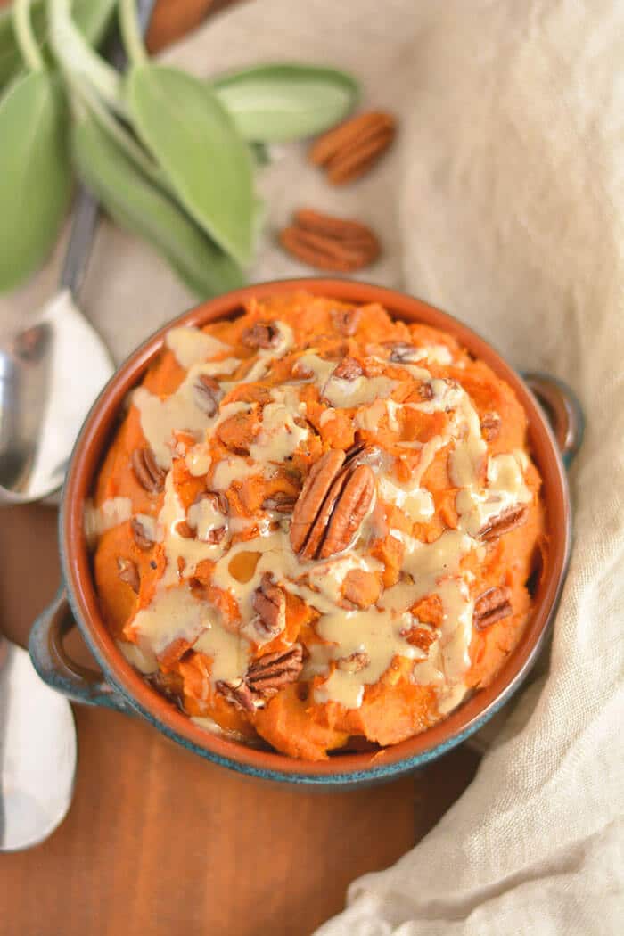 This warm Maple Tahini Butternut Sweet Potato Mash is a healthier version of sweet potato casserole. Lightly sweetened with maple syrup, savory tahini sauce and topped with pecans to make the perfect side dish for fall, winter and holiday gatherings. Gluten Free + Low Calorie + Vegan + Paleo