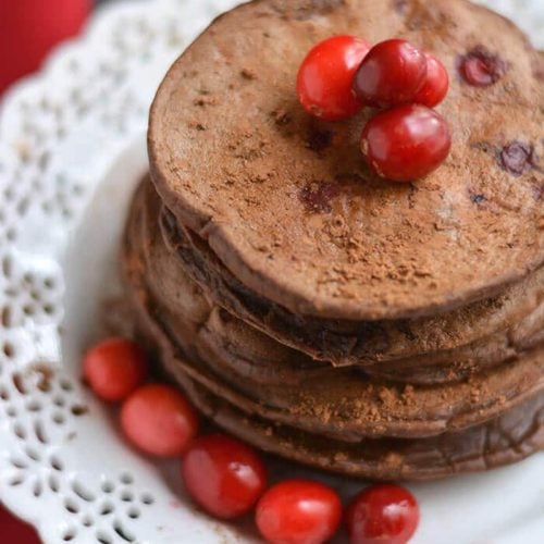 Creamy Cranberry Cocoa Pancakes that taste like hot cocoa! High in antioxidants & packed with protein, this crepe-like stack is bursting with sweetness. A guaranteed crowd pleaser! Gluten Free + Low Calorie