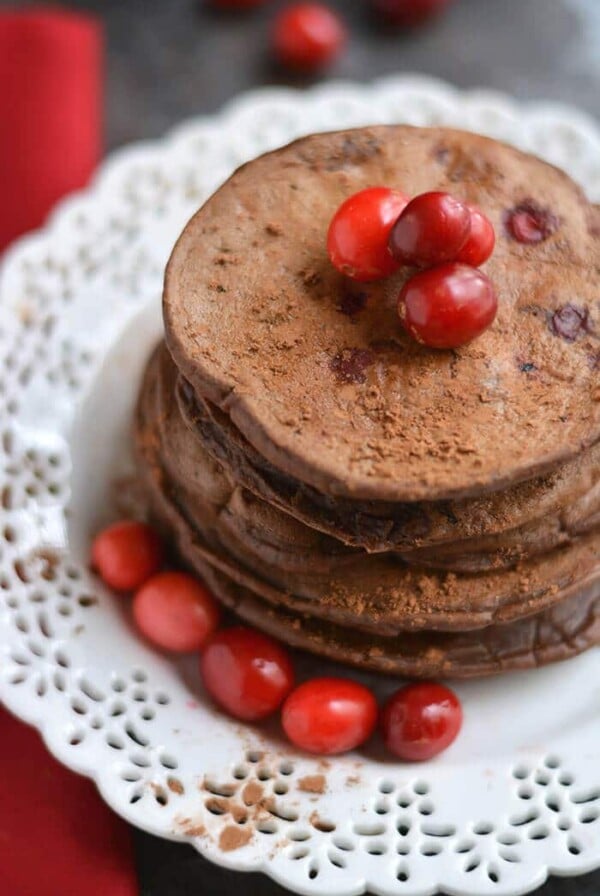 Creamy Cranberry Cocoa Pancakes that taste like hot cocoa! High in antioxidants & packed with protein, this crepe-like stack is bursting with sweetness. A guaranteed crowd pleaser! Gluten Free + Low Calorie