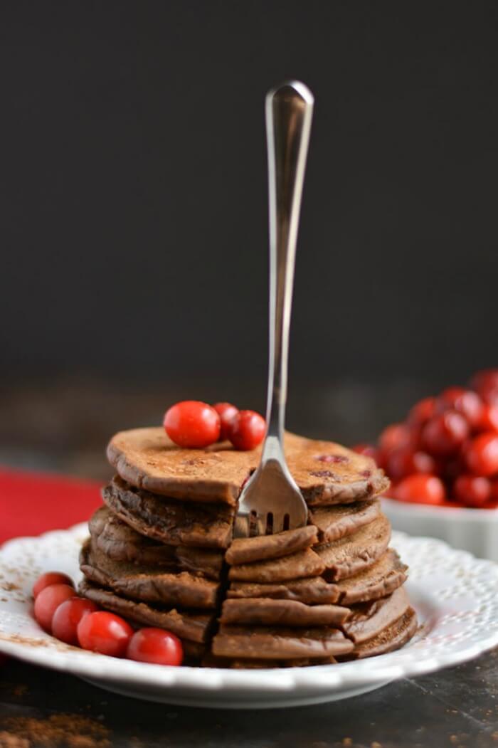 Creamy Cranberry Cocoa Pancakes that taste like hot cocoa! High in antioxidants & packed with protein, this crepe-like stack is bursting with sweetness. A guaranteed crowd pleaser! Gluten Free + Low Calorie