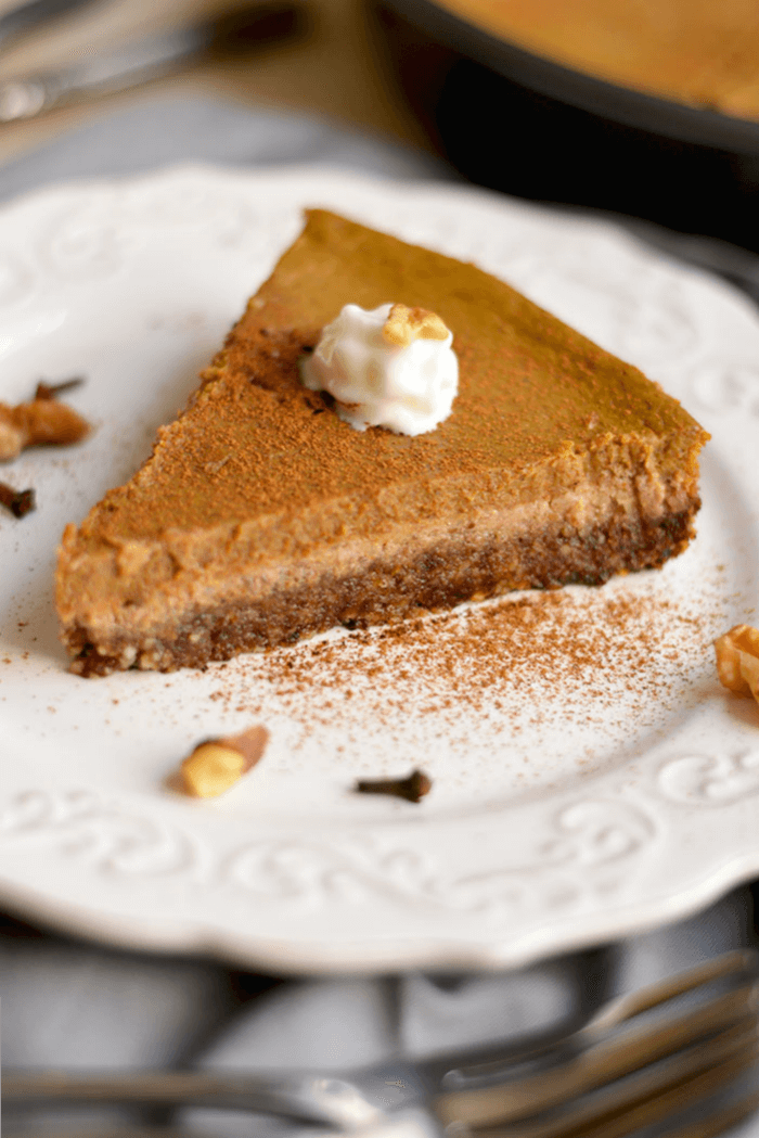 This Healthy Pumpkin Pie made with an addicting walnut date crust & topped with pumpkin custard is super easy to make & so delicious you won't want to share! What pumpkin pie dreams are made of! Gluten Free + Low Calorie + Paleo