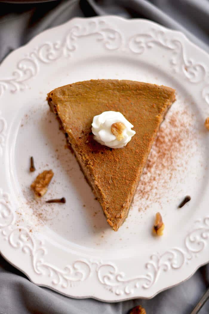 This Healthy Pumpkin Pie made with an addicting walnut date crust & topped with pumpkin custard is super easy to make & so delicious you won't want to share! What pumpkin pie dreams are made of! Gluten Free + Low Calorie + Paleo