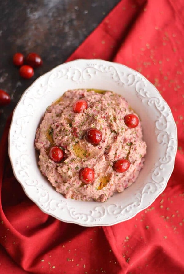 Spice things up with a Cranberry Hummus! This twist on traditional hummus makes a tasty holiday appetizer or winter snack, & guaranteed to add a kick to your plate! Gluten Free + Low Calorie + Vegan