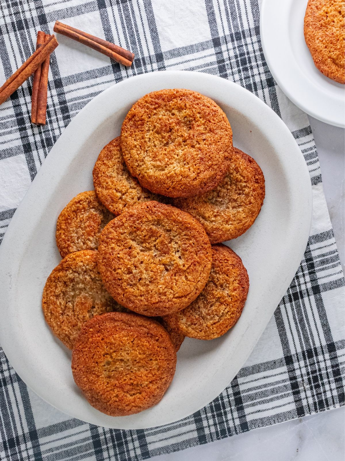 Gluten-free snickerdoodle cookies on a white plate. 