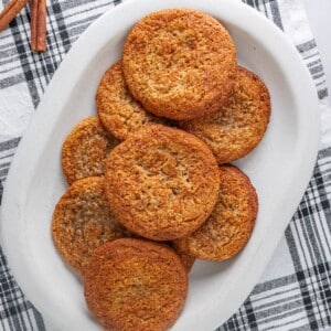 A plate of gluten-free snickerdoodles on a black and white plain napkin.