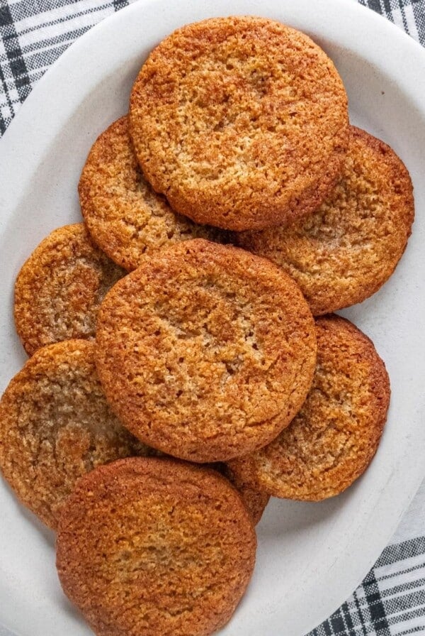 A plate of gluten-free snickerdoodles on a black and white plain napkin.
