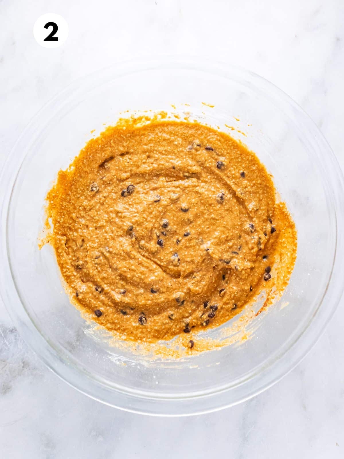 Dry ingredients combined with wet ingredients in the bowl.