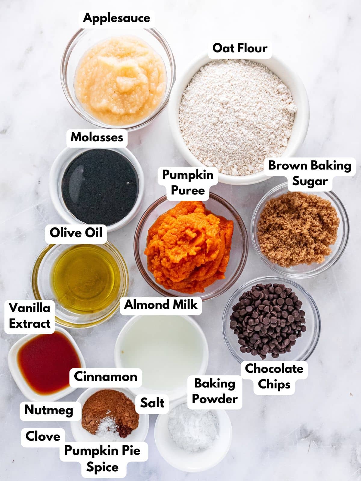 Ingredients for making pumpkin oatmeal muffins in bowls.