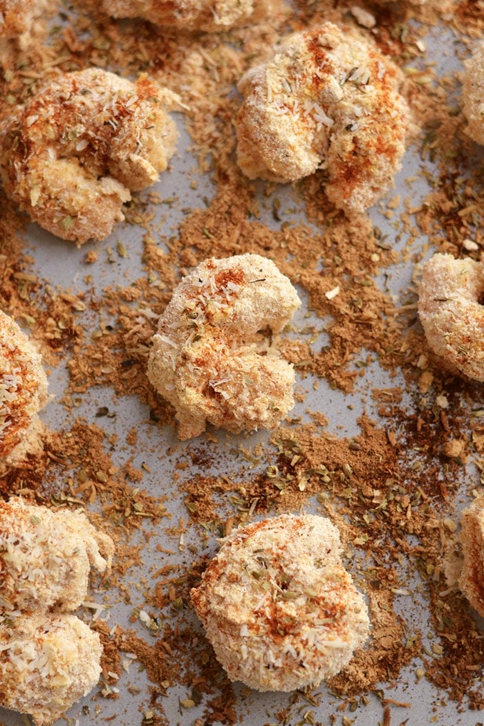 One Pan Baked Coconut Shrimp! Crispy, crunchy, spicy shrimp baked to perfection on a sheet pan. A "breaded" shrimp recipe that's healthy and grain free. Gluten Free + Low Calorie + Paleo