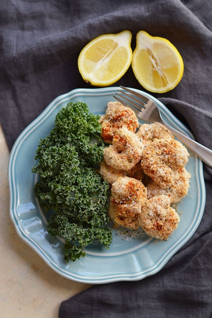 One Pan Baked Coconut Shrimp! Crispy, crunchy, spicy shrimp baked to perfection on a sheet pan. A "breaded" shrimp recipe that's healthy and grain free. Gluten Free + Low Calorie + Paleo