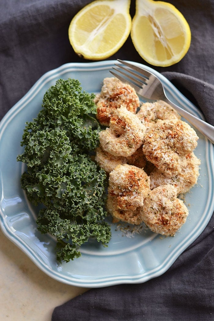 One Pan Baked Coconut Shrimp! Crispy, crunchy, spicy shrimp baked to perfection on a sheet pan. A "breaded" shrimp recipe that's healthy and grain free. Gluten Free + Low Calorie + Paleo