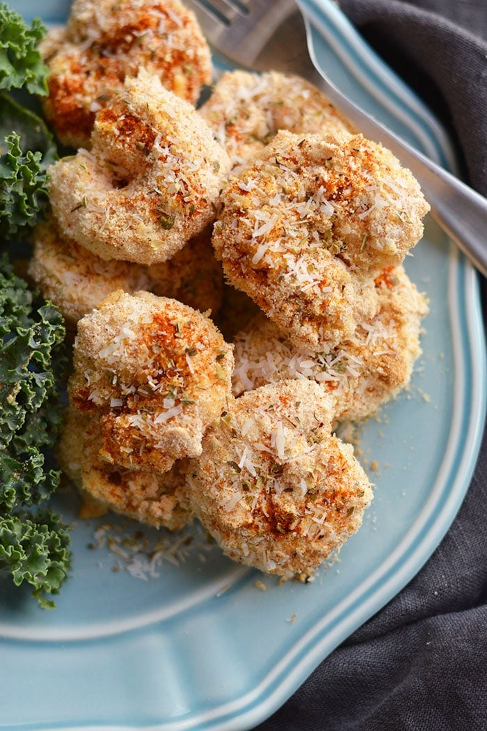 One Pan Baked Coconut Shrimp! Crispy, crunchy, spicy shrimp baked to perfection on a sheet pan. A "breaded" shrimp recipe that's healthy and grain free. Gluten Free + Low Calorie + Paleo