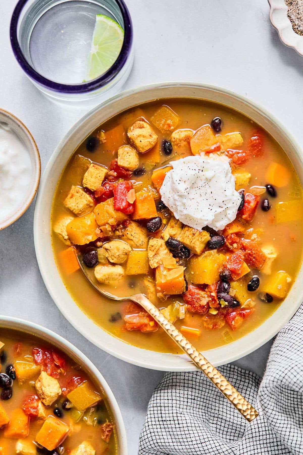 A bowl of red chicken chili with a dollop of Greek yogurt on top.