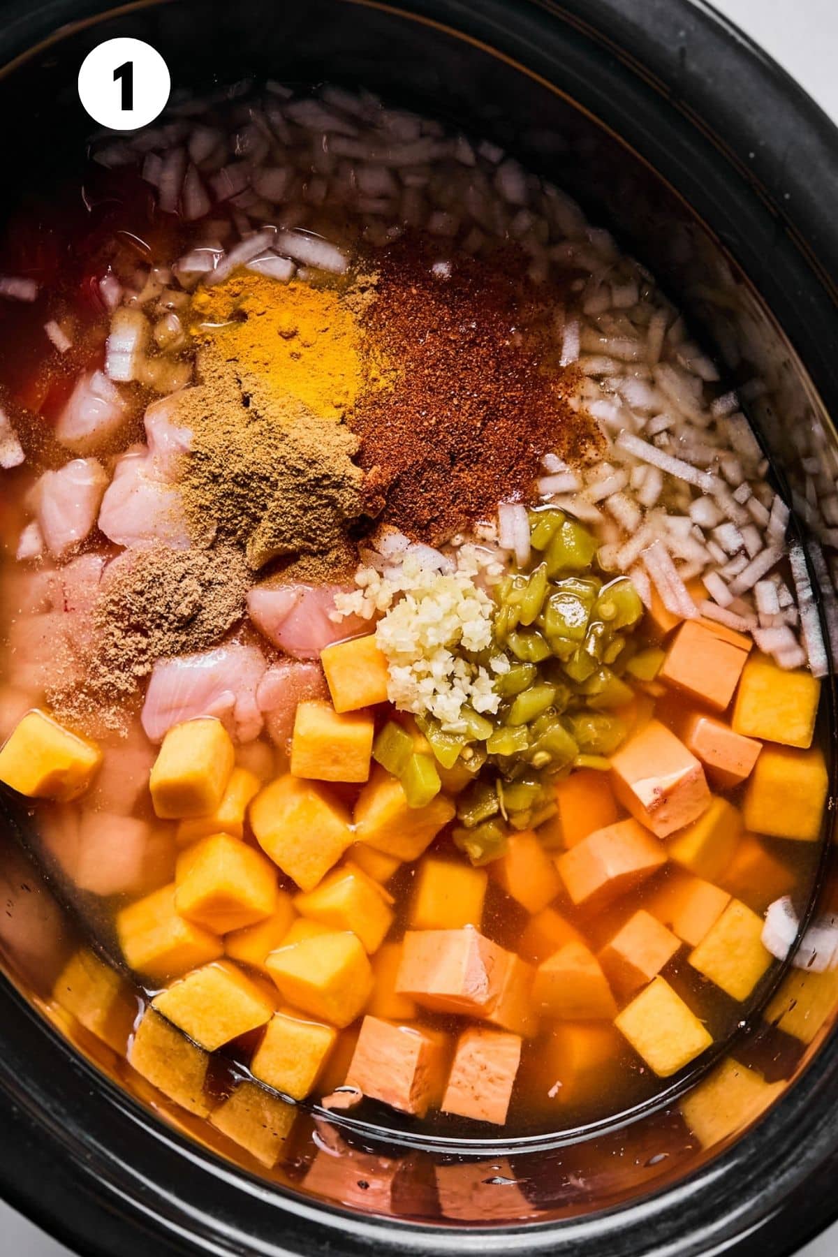All the ingredients added to the slow cooker.