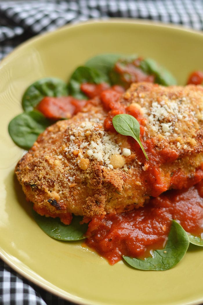 Crispy, cheesy Sheet Pan Chicken Parmesan baked to perfection with a kick of spice & juicy marinara sauce. A healthy alternative to deep frying that will win over any hungry heart. Gluten Free + Low Calorie Weight Loss Friendly Recipe