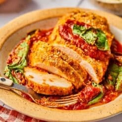 Crispy, cheesy Sheet Pan Chicken Parmesan baked to perfection with a kick of spice & juicy marinara sauce. A healthy alternative to deep frying that will win over any hungry heart. Gluten Free + Low Calorie Weight Loss Friendly Recipe