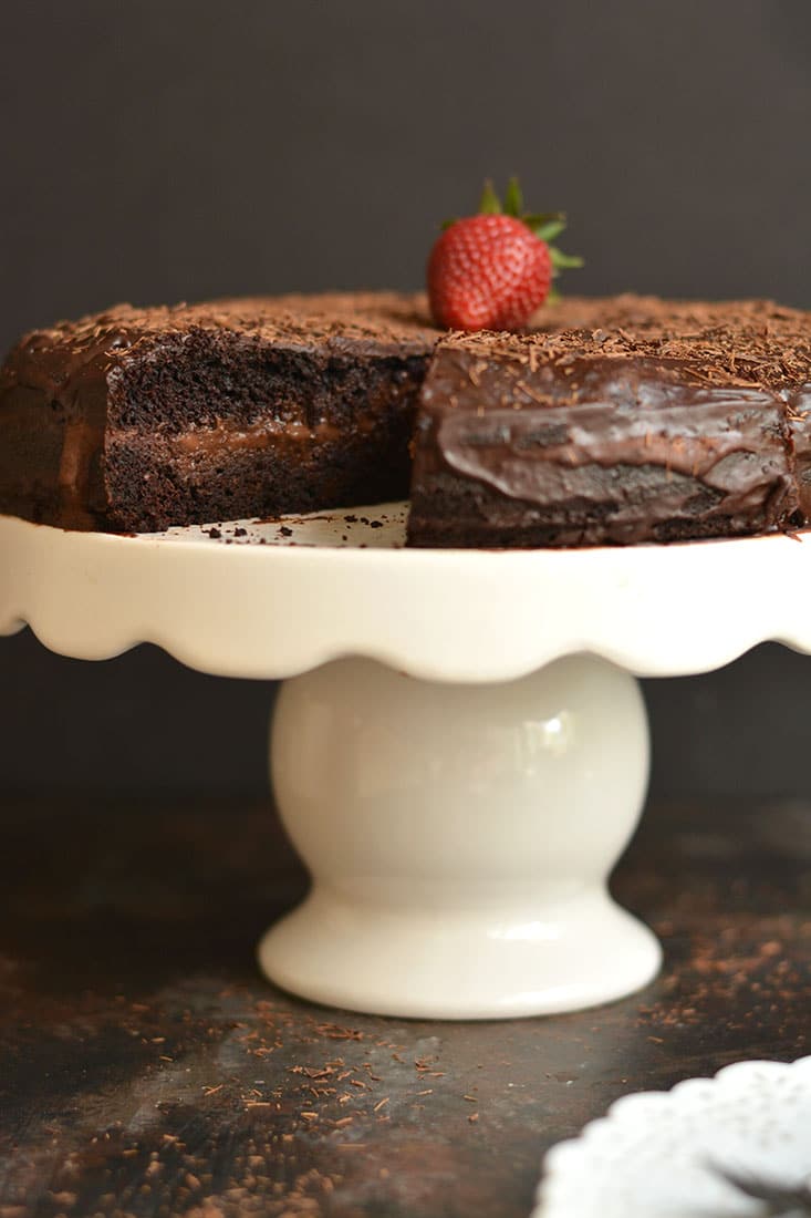 This Paleo Healthy Chocolate Cake is a healthier version of cake and easy to make with almond flour, maple syrup, cocoa, coconut cream & chocolate. The chocolate ganache center is truly irresistible. Guaranteed to be loved by the entire family! Gluten Free + Low Calorie + Paleo