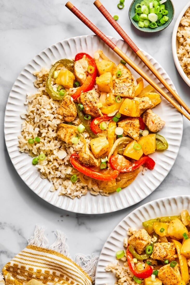 Healthy sweet and sour chicken on white plates. 