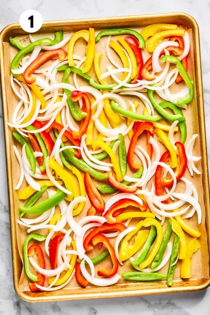 Vegetables spread on a baking pan. 