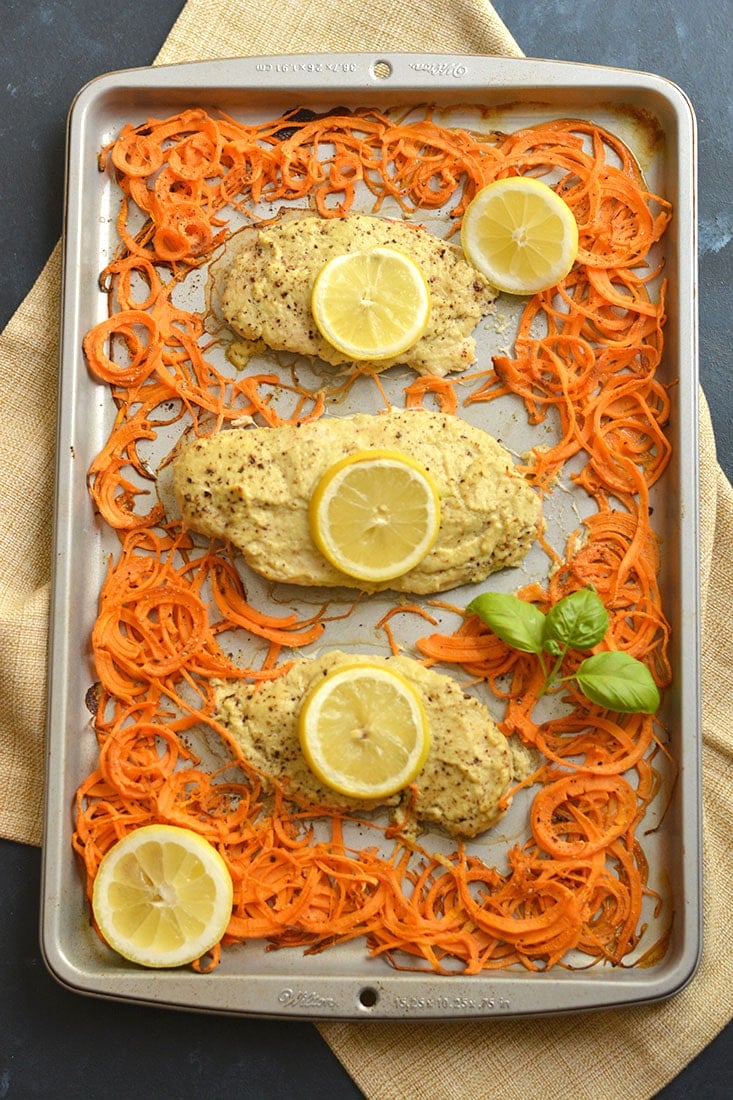 Sheet Pan Hummus Chicken marinated in Paleo zucchini hummus turns boring chicken into a flavorful meal. Paired with spiralized sweet potato for a french fry like side. All made on one sheet pan in 20 minutes! Paleo + Gluten Free + Low Calorie