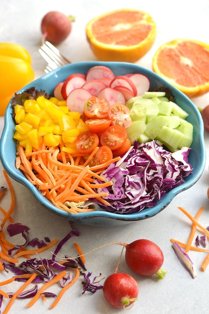 A Rainbow Detox Salad packed with fresh, healthy ingredients and a light orange dressing. Crisp cabbage, radishes, cucumber, and more! Easy to make fresh at home all in one bowl. Just toss and go! Great as a healthy vegetarian main or a side salad for any dish! Paleo + Vegan + Gluten Free + Low Calorie