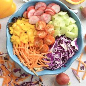 A Rainbow Detox Salad packed with fresh, healthy ingredients and a light orange dressing. Crisp cabbage, radishes, cucumber, and more! Easy to make fresh at home all in one bowl. Just toss and go! Great as a healthy vegetarian main or a side salad for any dish! Paleo + Vegan + Gluten Free + Low Calorie