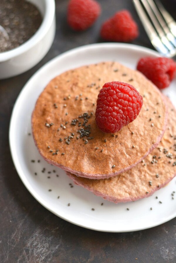 Raspberry Chia Protein Pancakes are too good to be true! Protein packed, made with simple wholesome ingredients, lower in sugar, and so tasty! Just blend, cook, and eat! Gluten Free + Low Calorie