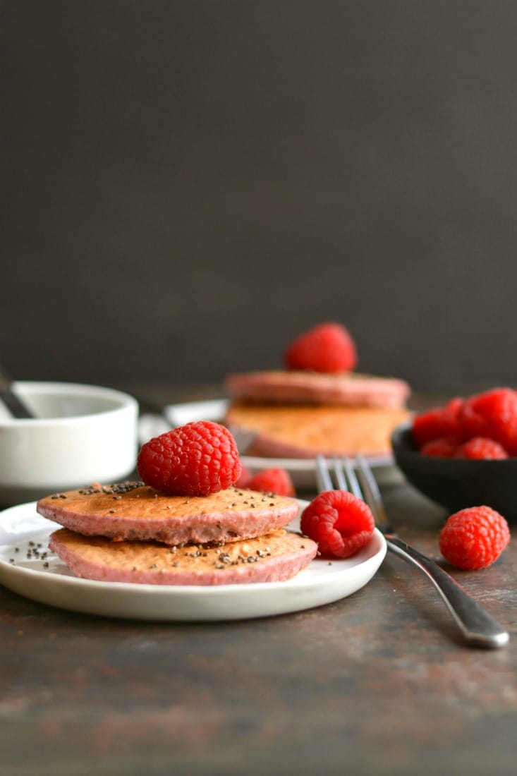 Raspberry Chia Protein Pancakes are too good to be true! Protein packed, made with simple wholesome ingredients, lower in sugar, and so tasty! Just blend, cook, and eat! Gluten Free + Low Calorie