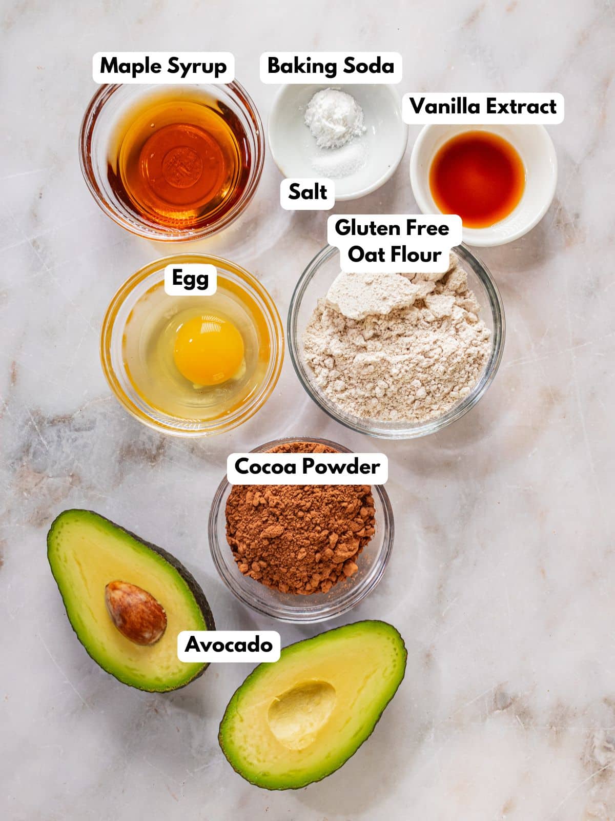 Ingredients to make these avocado chocolate cookie in bowls on a table.