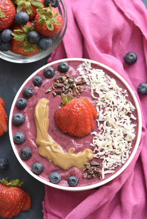 A tasty PB&J Superfood Smoothie made with acai, protein powder, fruit, nut butter, Greek yogurt & more! A vitamin & mineral packed breakfast or snack, resembling a favorite childhood sandwich. Gluten Free + Low Calorie!