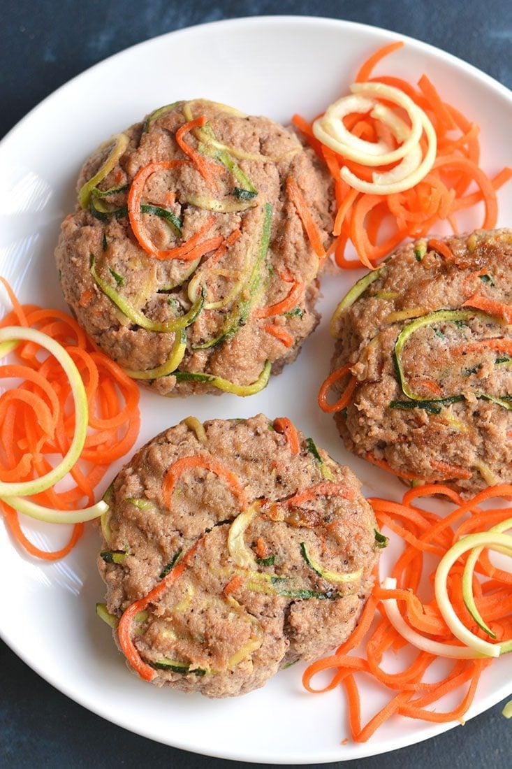Spiralized Turkey Burgers with Zucchini & Carrots! These burgers make a bold statement with curly strands of veggies. With 4 ingredients & 10 minutes to make, this veggie packed recipe is one anyone can make. Paleo + Gluten Free + Low Calorie
