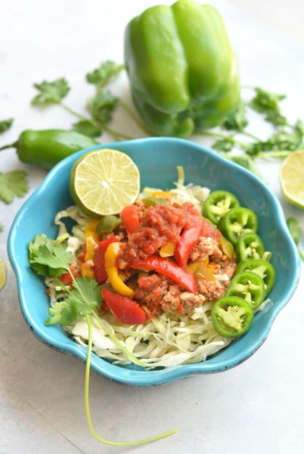 Healthy Skillet Salsa Chicken! Loaded with protein, veggies & flavor, this super easy 15 minute dinner is a family favorite. Serve over lettuce with rice or quinoa, or cauliflower rice for Paleo. Gluten Free + Low Calorie + Paleo
