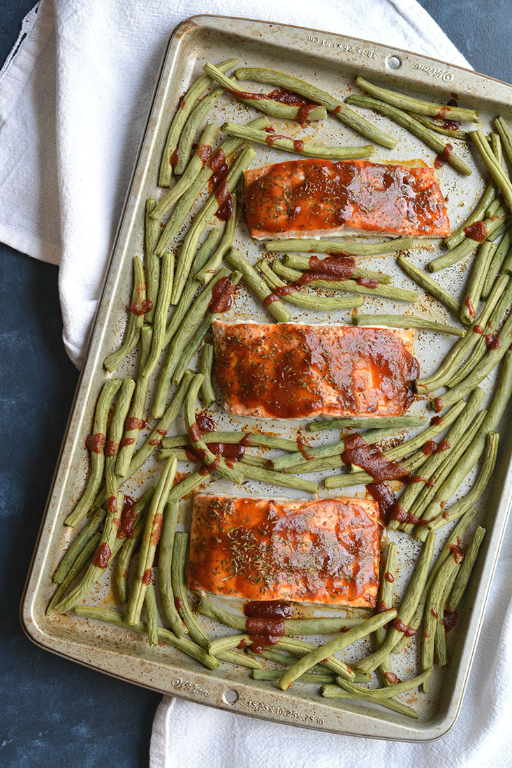 Low Sugar BBQ Salmon made on a sheet pan in less than 20 minutes. Low sugar BBQ sauce, thyme & green beans compliment the meal perfect. A hearty, yet healthy meal with simple good for you ingredients. Gluten Free + Low Calorie