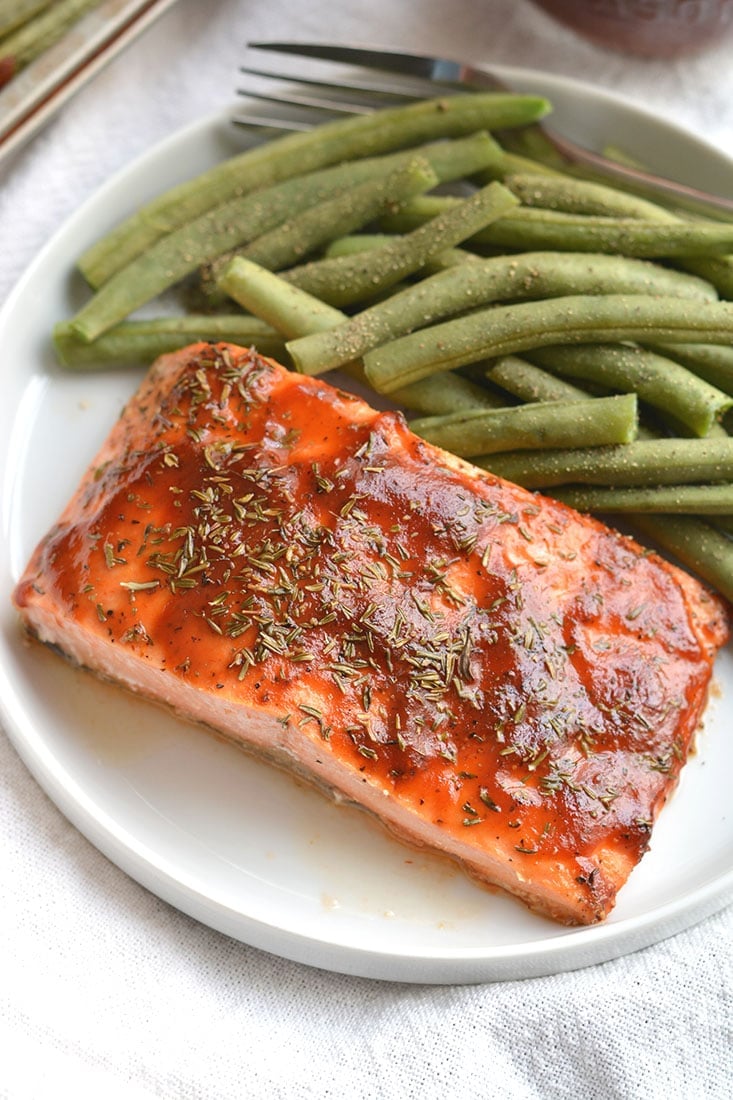 Low Sugar BBQ Salmon made on a sheet pan in less than 20 minutes. Low sugar BBQ sauce, thyme & green beans compliment the meal perfect. A hearty, yet healthy meal with simple good for you ingredients. Gluten Free + Low Calorie