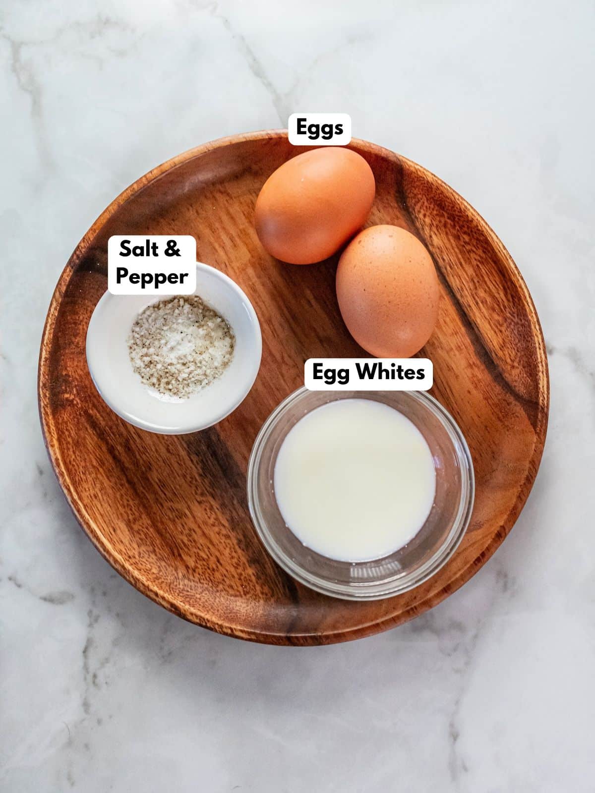 Ingredients to make scrambled eggs in the microwave on a plate.