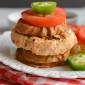 Grilled Sriracha Parsley Chicken Burgers! Sriracha & parsley mixed with chicken, make these burgers to die for! These flavorful, herby, burgers have a hidden kick & can be made on the stove, grill or in the oven. Paleo + Gluten Free + Low Calorie