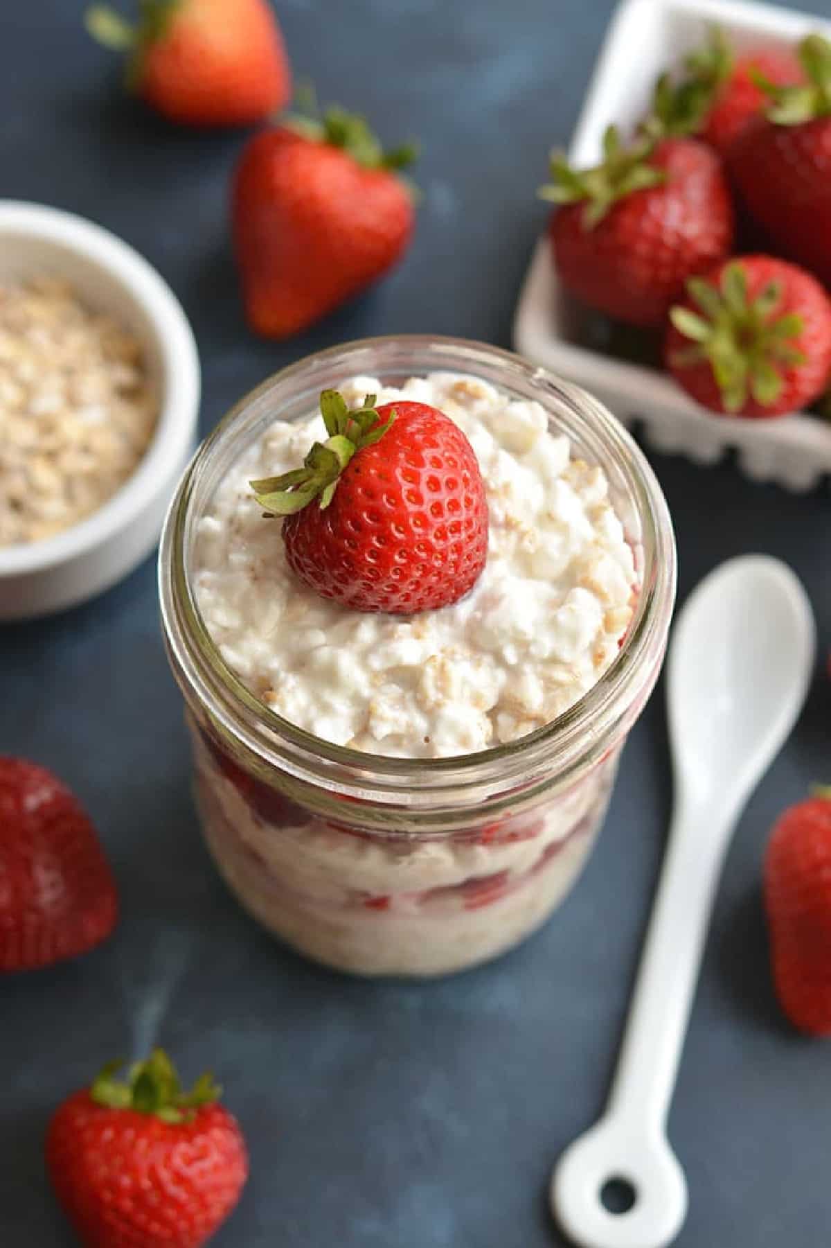 cottage cheese in a glass with a strawberry on top.