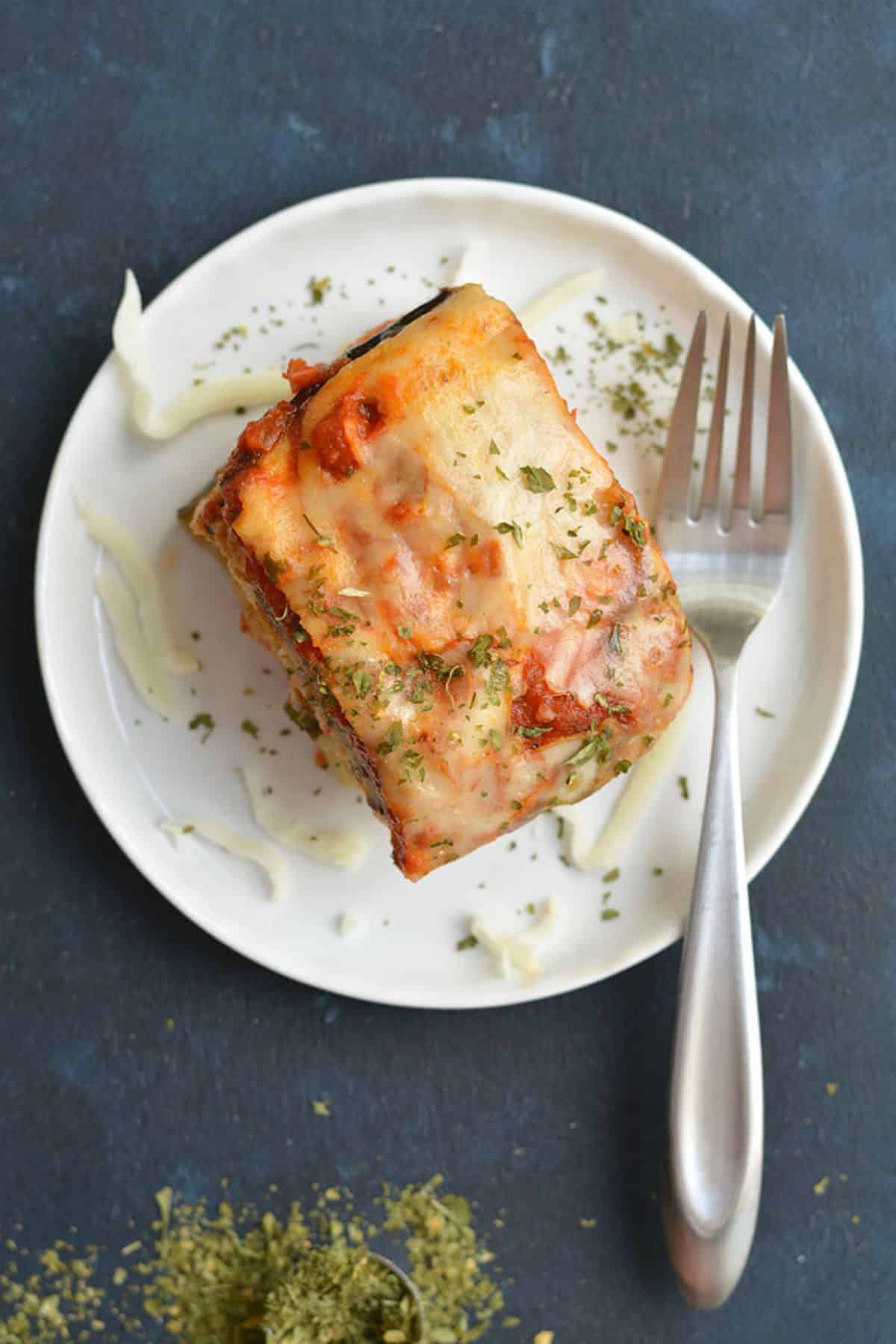 A slice of low carb crockpot lasagna on a plate.