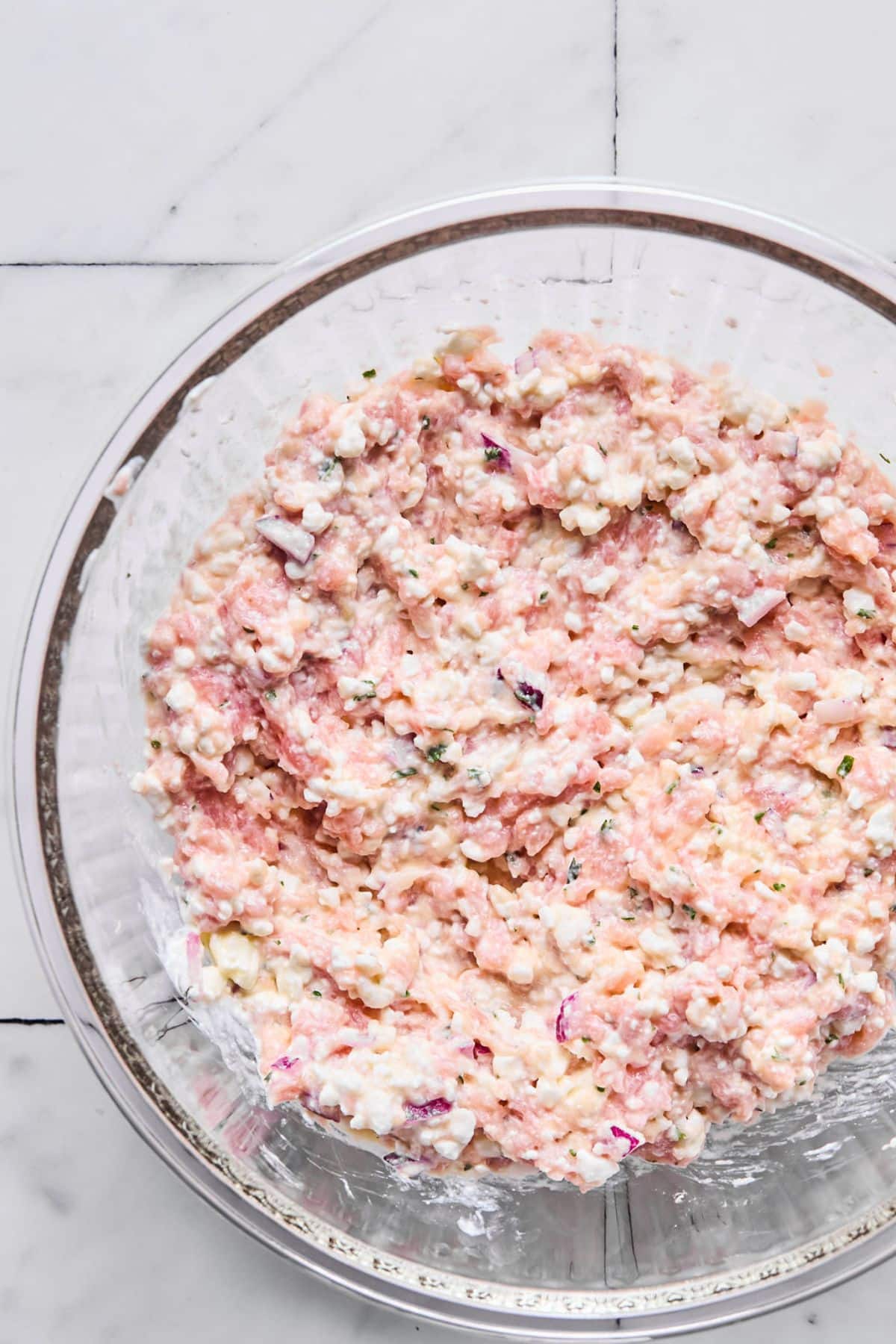 Ingredients for making lasagna filling mixed together in a bowl.