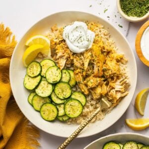 Slow cooker chicken shawarma in a bowl with rice and zucchini.