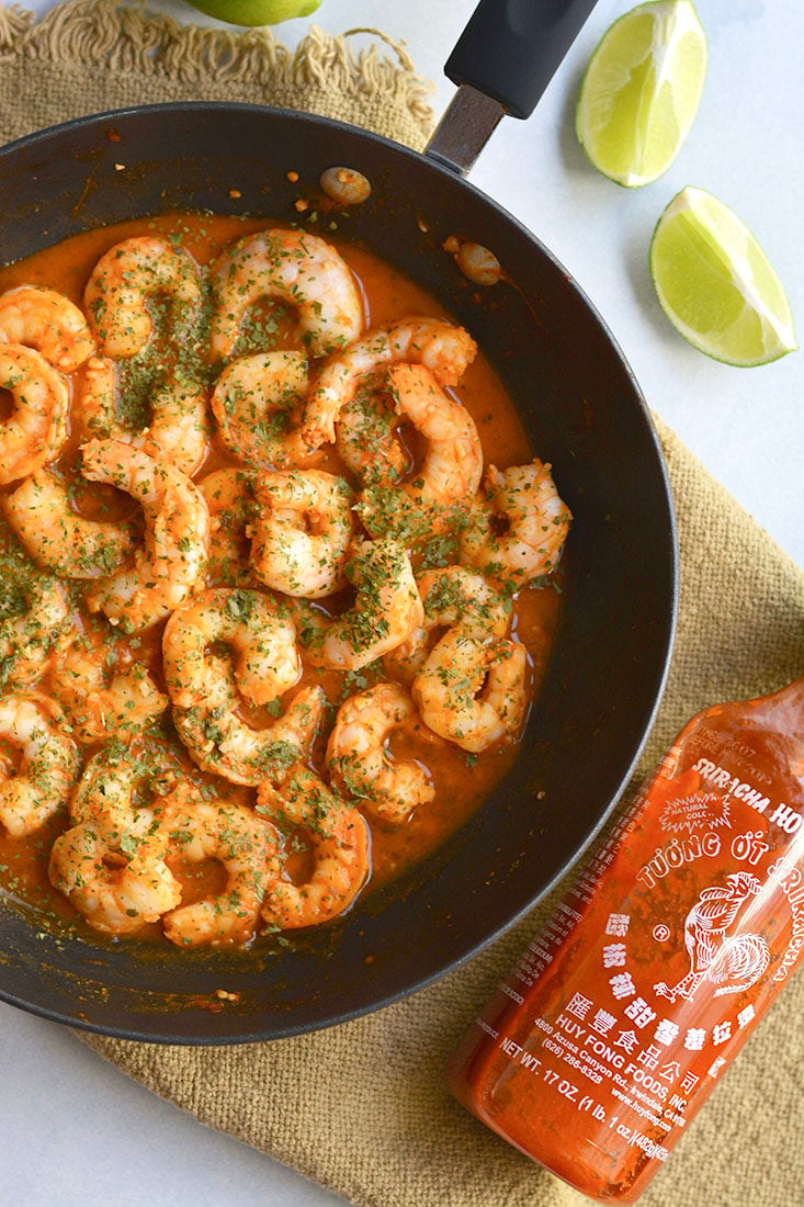 Spicy Sriracha Shrimp made two ways! Tender shrimp tossed in garlic, lime and Sriracha then cooked to perfection. A low carb, Gluten Free and Paleo meal made in less than 15 minutes! Gluten Free + Low Calorie + Paleo