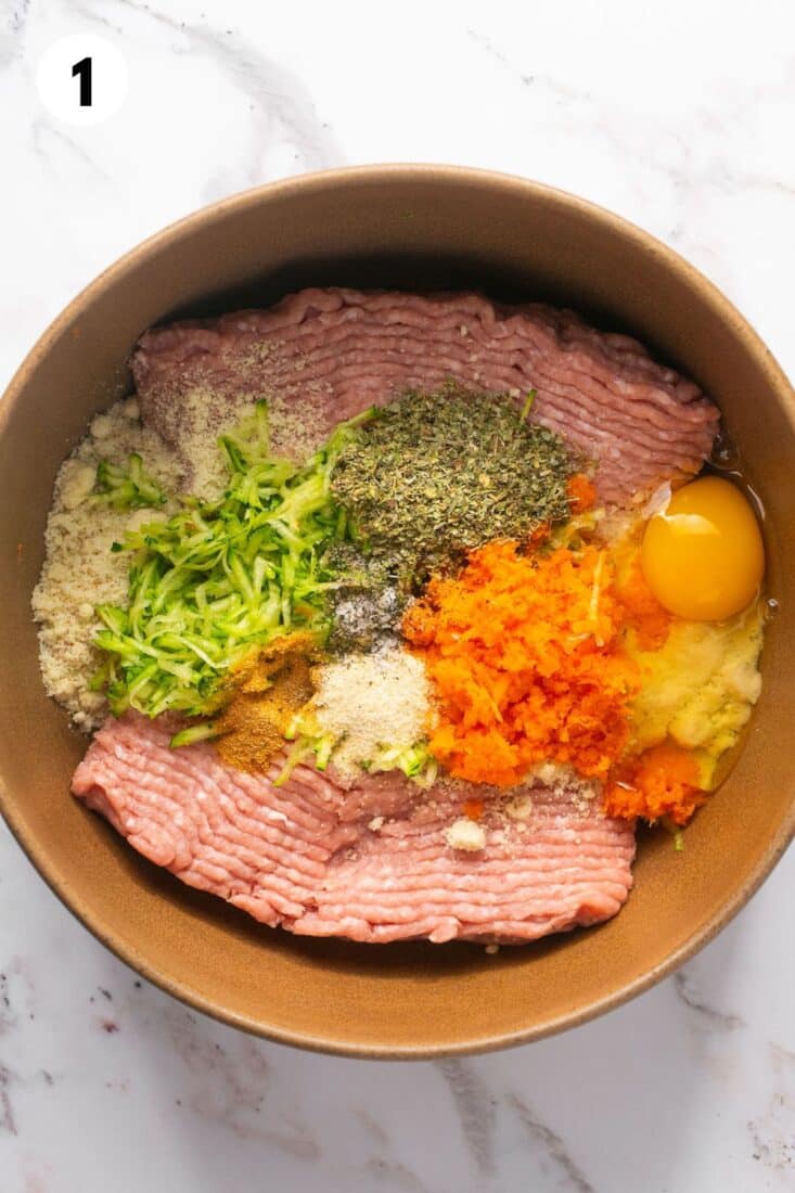 Meatloaf ingredients in a mixing bowl before mixing.